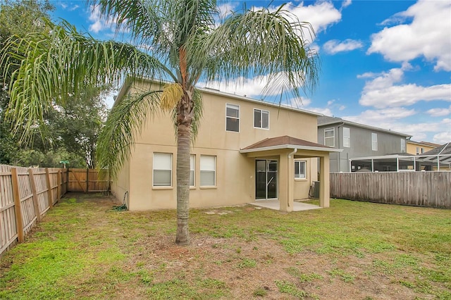 13510 Copper Belly Ct, Riverview, FL 33569 - rear view of house with stucco siding, a fenced backyard, and a patio area