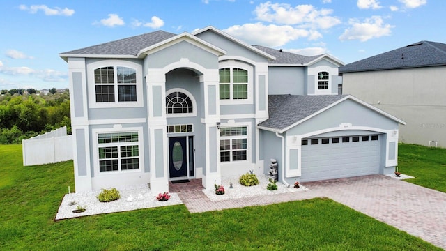 5209 Cape Hatteras Dr, Clermont, FL 34714 - view of front facade featuring an attached garage, stucco siding, decorative driveway, and a shingled roof
