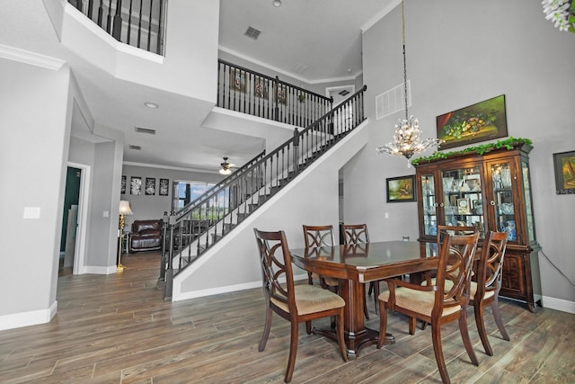 5209 Cape Hatteras Dr, Clermont, FL 34714 - dining space with stairs, a high ceiling, wood finished floors, ceiling fan, and a chandelier