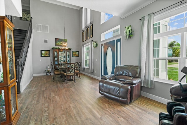 5209 Cape Hatteras Dr, Clermont, FL 34714 - entrance foyer featuring plenty of natural light, wood finished floors, stairs, ornamental molding, and a chandelier