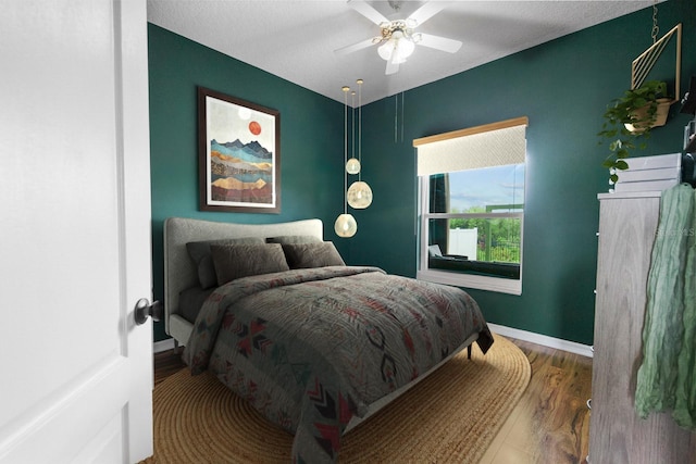 5209 Cape Hatteras Dr, Clermont, FL 34714 - bedroom with wood finished floors and a ceiling fan