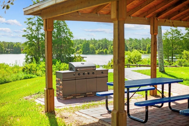 5209 Cape Hatteras Dr, Clermont, FL 34714 - view of patio / terrace with a water view, a forest view, a gazebo, and grilling area