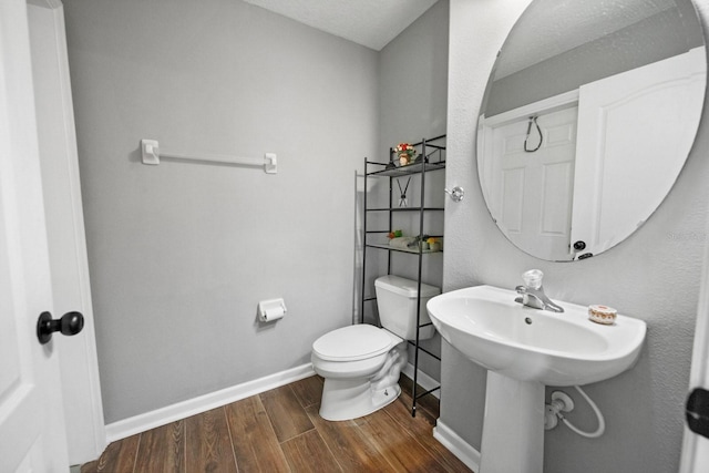 5209 Cape Hatteras Dr, Clermont, FL 34714 - bathroom with wood finished floors and toilet
