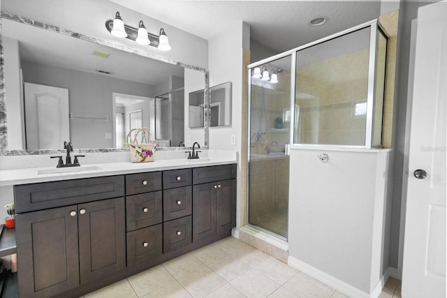 5209 Cape Hatteras Dr, Clermont, FL 34714 - bathroom featuring double vanity, a shower stall, and tile patterned floors