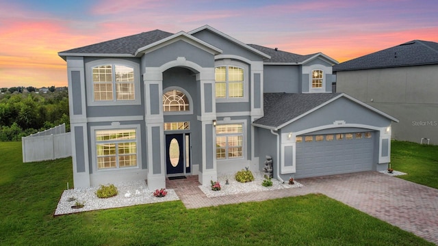 5209 Cape Hatteras Dr, Clermont, FL 34714 - traditional-style home featuring stucco siding, a garage, decorative driveway, and roof with shingles