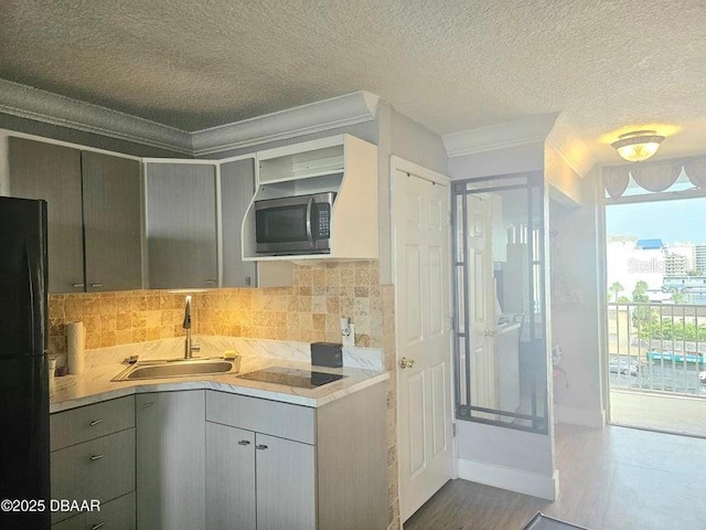 3501 S Atlantic Ave Unit 5020, Daytona Beach, FL 32118 - kitchen with black appliances, crown molding, a textured ceiling, gray cabinets, and backsplash