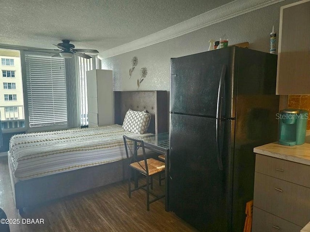 3501 S Atlantic Ave Unit 5020, Daytona Beach, FL 32118 - bedroom with freestanding refrigerator, wood finished floors, a textured ceiling, ornamental molding, and a textured wall
