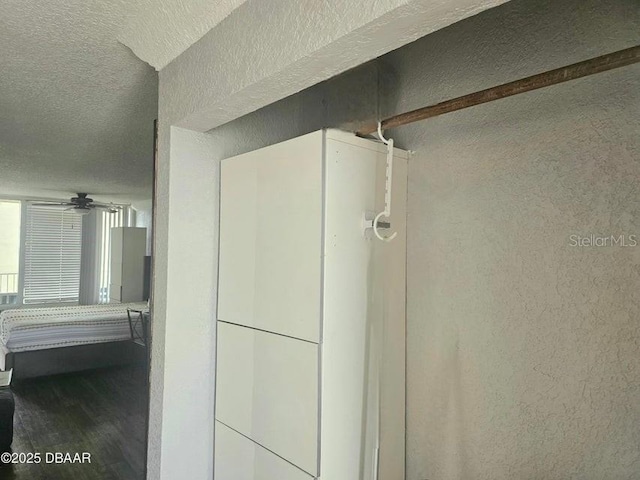 3501 S Atlantic Ave Unit 5020, Daytona Beach, FL 32118 - bathroom featuring a textured wall, a textured ceiling, a ceiling fan, and wood finished floors