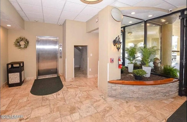 3501 S Atlantic Ave Unit 5020, Daytona Beach, FL 32118 - corridor featuring elevator, a drop ceiling, stone finish flooring, and recessed lighting