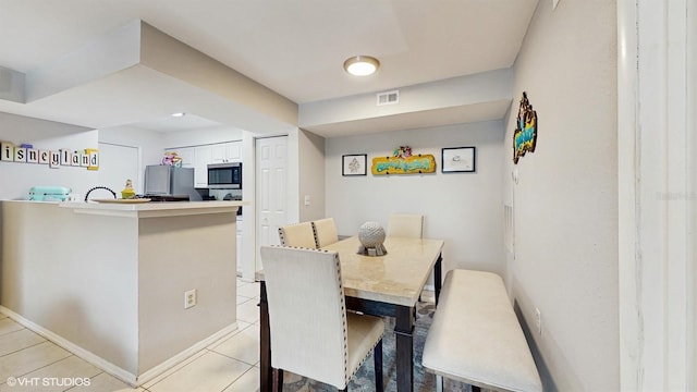 3012 Parkway Blvd Unit 203, Kissimmee, FL 34747 - dining room featuring light tile patterned flooring and baseboards