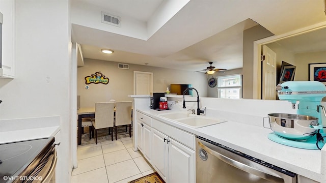 3012 Parkway Blvd Unit 203, Kissimmee, FL 34747 - kitchen with stainless steel appliances, light tile patterned floors, white cabinetry, a ceiling fan, and light countertops
