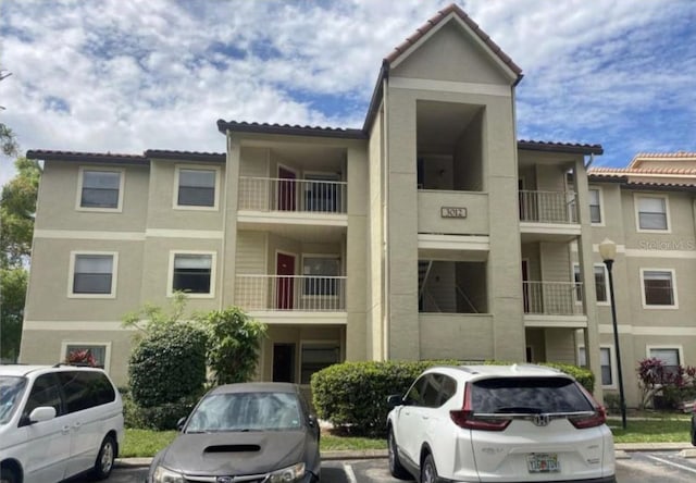 3012 Parkway Blvd Unit 203, Kissimmee, FL 34747 - view of building exterior featuring uncovered parking