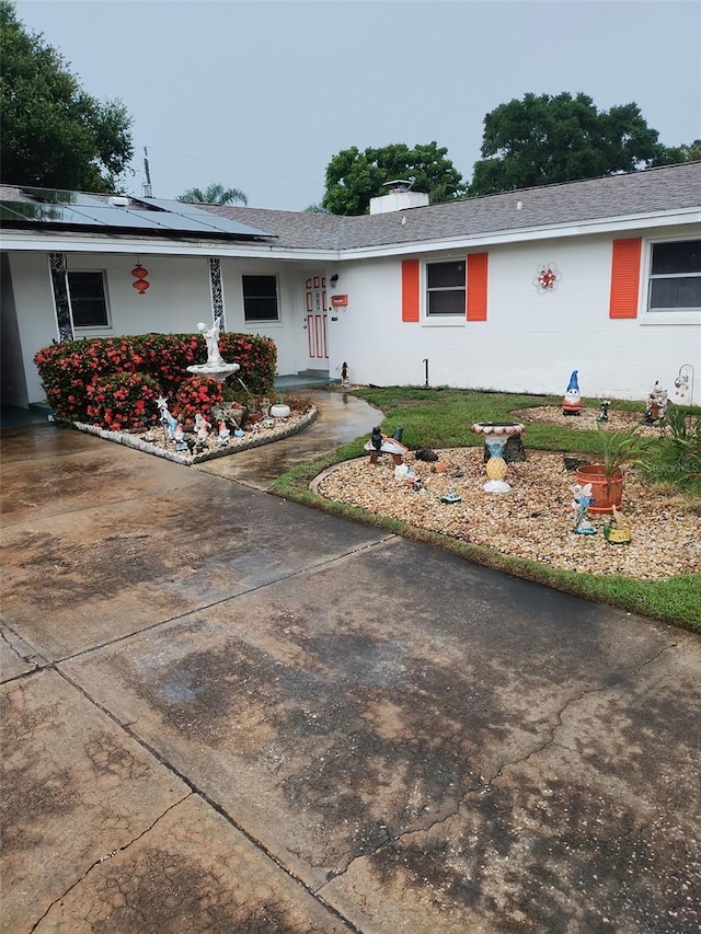 4427 Gilpin Way, Orlando, FL 32812 - ranch-style home with roof mounted solar panels and a chimney