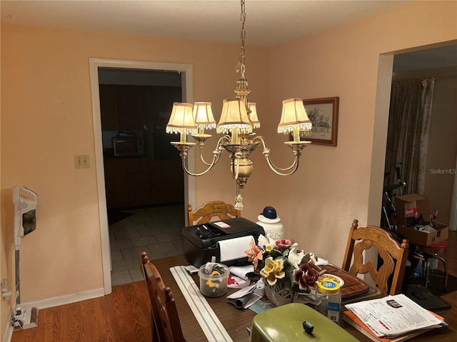 4427 Gilpin Way, Orlando, FL 32812 - dining area featuring a chandelier and wood finished floors