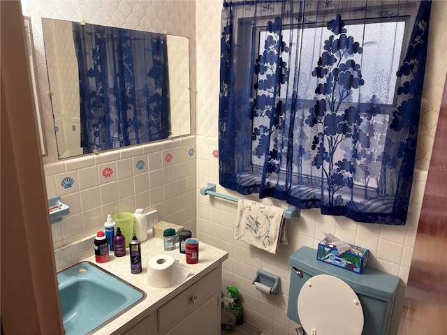 4427 Gilpin Way, Orlando, FL 32812 - bathroom featuring tile walls, wallpapered walls, and vanity