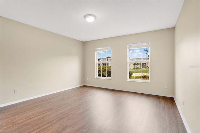 11813 Colyar Ln, Parrish, FL 34219 - spare room with wood finished floors and baseboards