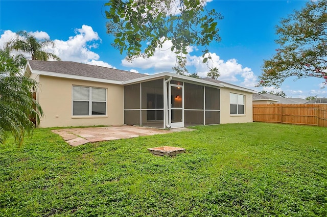 11813 Colyar Ln, Parrish, FL 34219 - back of house featuring a patio area, a sunroom, a fenced backyard, and stucco siding