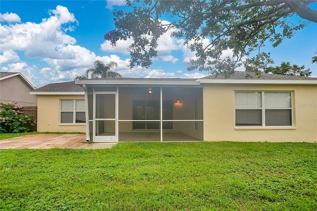 11813 Colyar Ln, Parrish, FL 34219 - back of property with a sunroom, stucco siding, and a patio