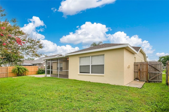 11813 Colyar Ln, Parrish, FL 34219 - rear view of house with stucco siding, a fenced backyard, a sunroom, and a gate