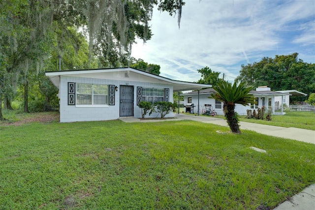 1831 Wilton Ave, Orlando, FL 32805 - view of front of house featuring a carport, driveway, and concrete block siding
