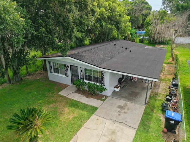 1831 Wilton Ave, Orlando, FL 32805 - view of front facade featuring an attached carport, a front yard, stucco siding, and concrete driveway