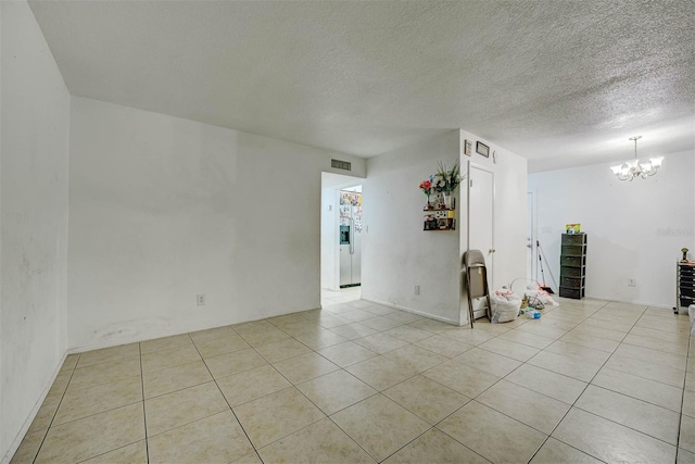 1831 Wilton Ave, Orlando, FL 32805 - tiled spare room with a chandelier and a textured ceiling