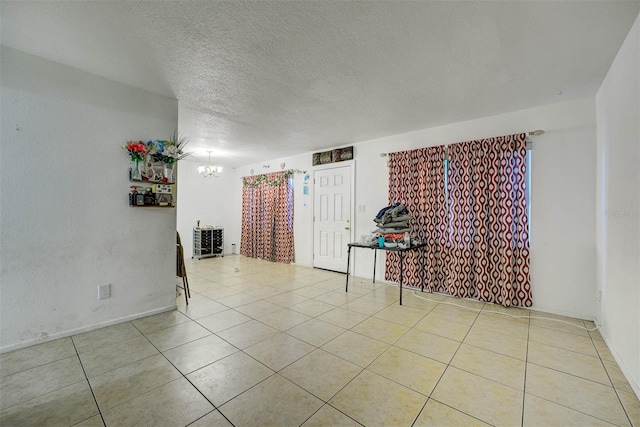 1831 Wilton Ave, Orlando, FL 32805 - tiled empty room featuring a chandelier and a textured ceiling