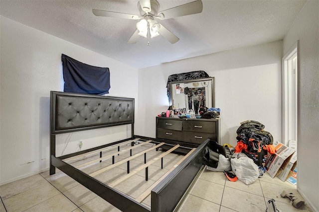 1831 Wilton Ave, Orlando, FL 32805 - bedroom with tile patterned flooring, a textured ceiling, and a ceiling fan