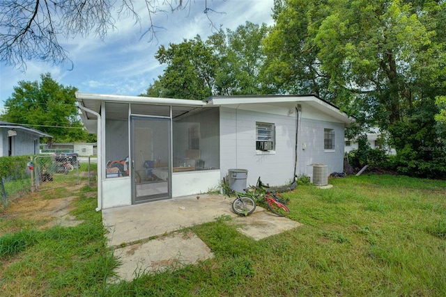 1831 Wilton Ave, Orlando, FL 32805 - back of house featuring a sunroom and a patio