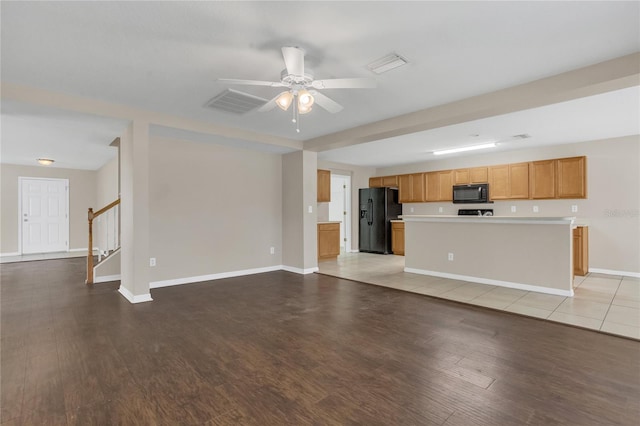 316 Crichton St, Ruskin, FL 33570 - unfurnished living room with light wood-type flooring, a ceiling fan, and stairs