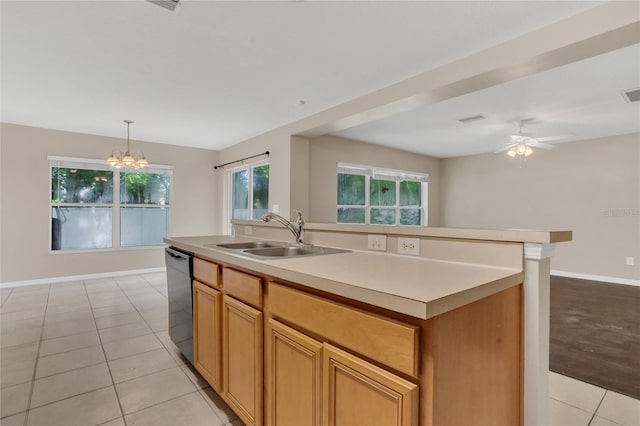 316 Crichton St, Ruskin, FL 33570 - kitchen with black dishwasher, light countertops, an island with sink, light tile patterned floors, and a chandelier