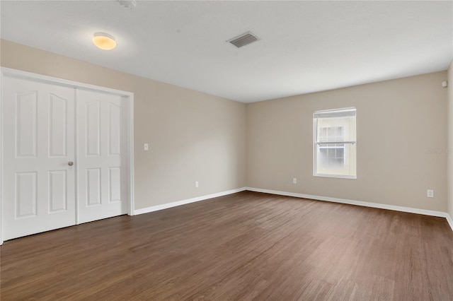 316 Crichton St, Ruskin, FL 33570 - unfurnished bedroom with dark wood-type flooring and a closet