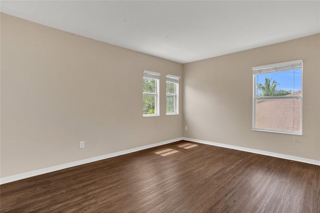316 Crichton St, Ruskin, FL 33570 - spare room featuring baseboards and dark wood-style flooring