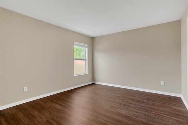 316 Crichton St, Ruskin, FL 33570 - empty room with dark wood-style floors and baseboards
