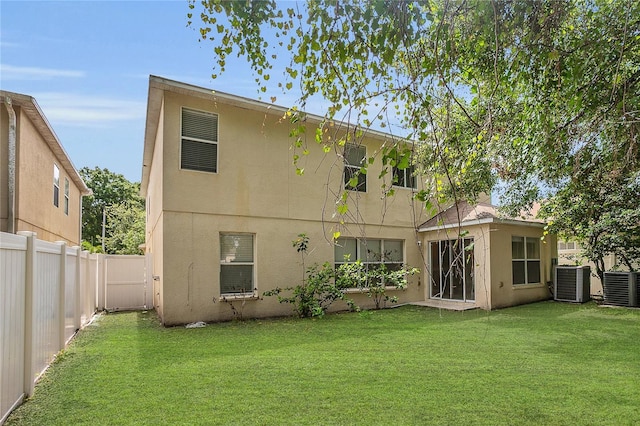 316 Crichton St, Ruskin, FL 33570 - rear view of house featuring stucco siding and a fenced backyard