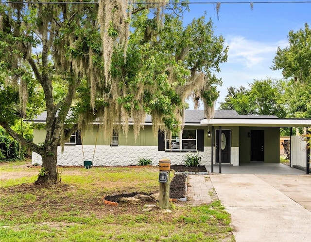 213 Flagler Ave, Edgewater, FL 32132 - view of front of home featuring driveway, an attached carport, and stone siding