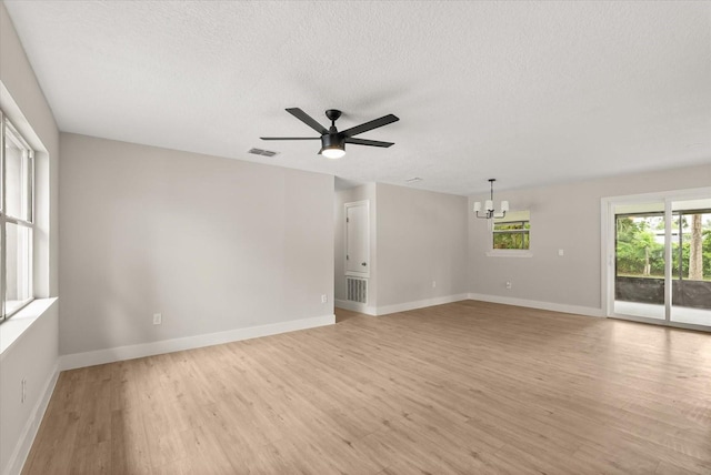 213 Flagler Ave, Edgewater, FL 32132 - empty room with light wood-type flooring, a chandelier, a textured ceiling, and ceiling fan