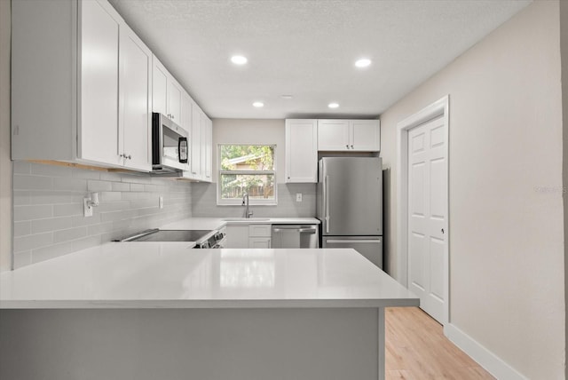 213 Flagler Ave, Edgewater, FL 32132 - kitchen with stainless steel appliances, light countertops, decorative backsplash, recessed lighting, and a textured ceiling