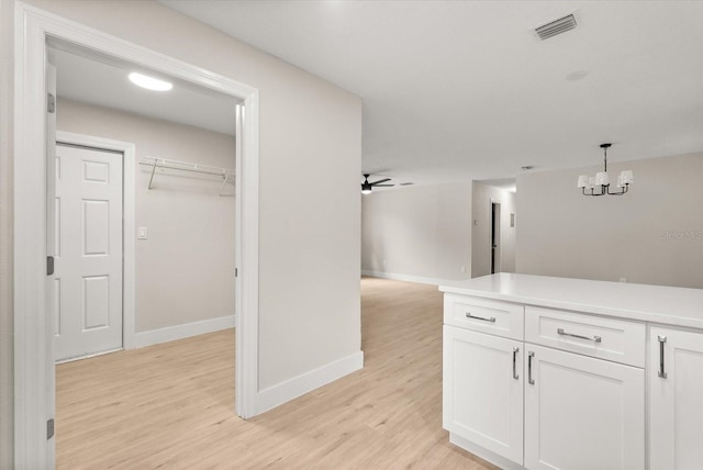 213 Flagler Ave, Edgewater, FL 32132 - hallway with light wood-style floors and a chandelier