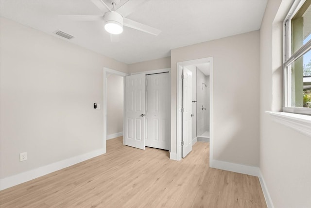 213 Flagler Ave, Edgewater, FL 32132 - unfurnished bedroom featuring light wood finished floors, ensuite bath, a closet, and a ceiling fan