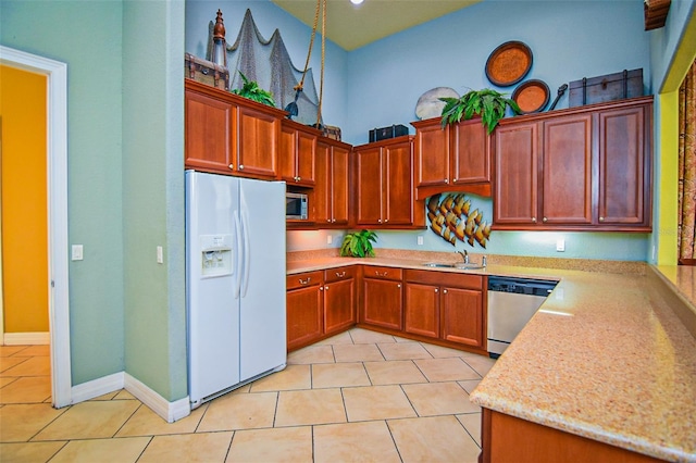 2426 Caravelle Cir, Kissimmee, FL 34746 - kitchen with appliances with stainless steel finishes, light tile patterned floors, and light stone countertops