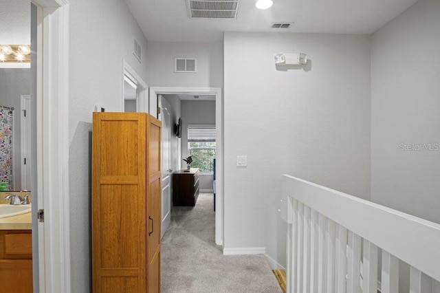 2426 Caravelle Cir, Kissimmee, FL 34746 - hall featuring light carpet and an upstairs landing