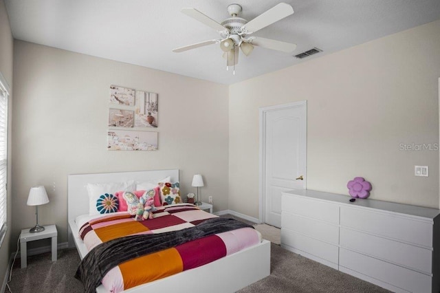2426 Caravelle Cir, Kissimmee, FL 34746 - carpeted bedroom with baseboards and a ceiling fan