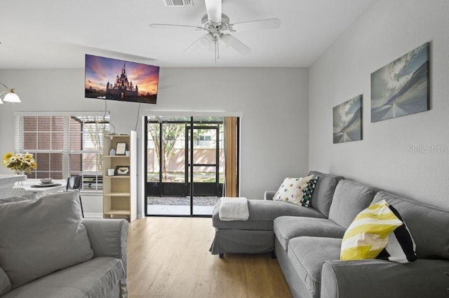 2426 Caravelle Cir, Kissimmee, FL 34746 - living room featuring wood finished floors, ceiling fan, and a chandelier