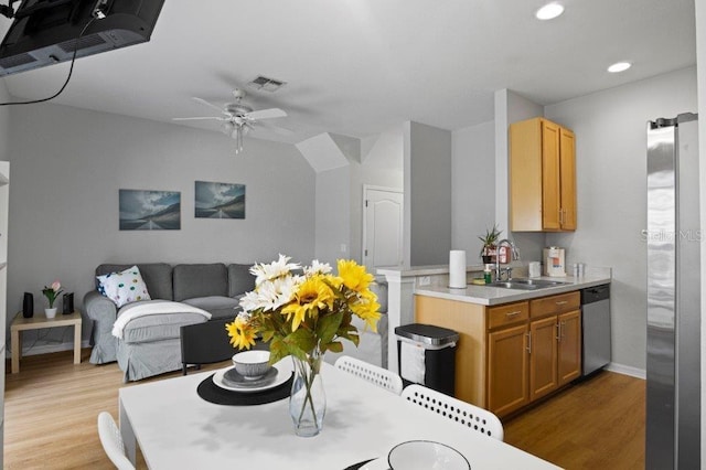 2426 Caravelle Cir, Kissimmee, FL 34746 - kitchen with stainless steel appliances, light wood finished floors, light countertops, recessed lighting, and a ceiling fan