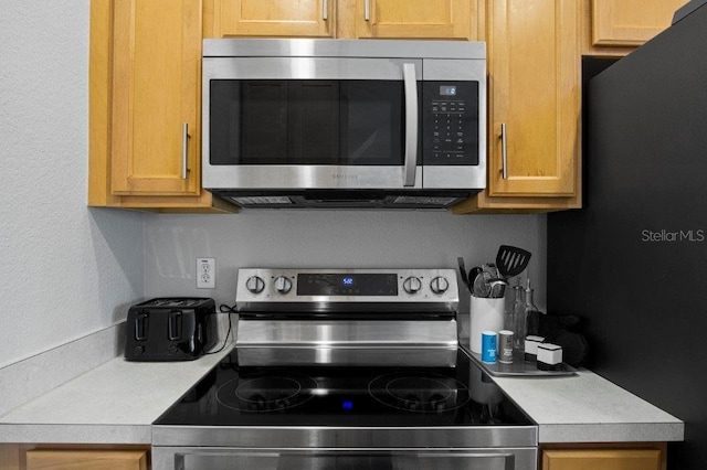 2426 Caravelle Cir, Kissimmee, FL 34746 - kitchen with stainless steel appliances and light countertops