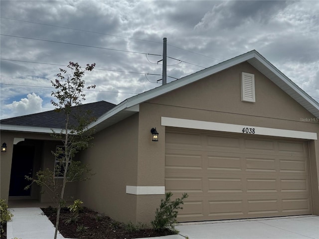4038 Sagefield Dr, Harmony, FL 34773 - view of property exterior featuring stucco siding, an attached garage, and concrete driveway