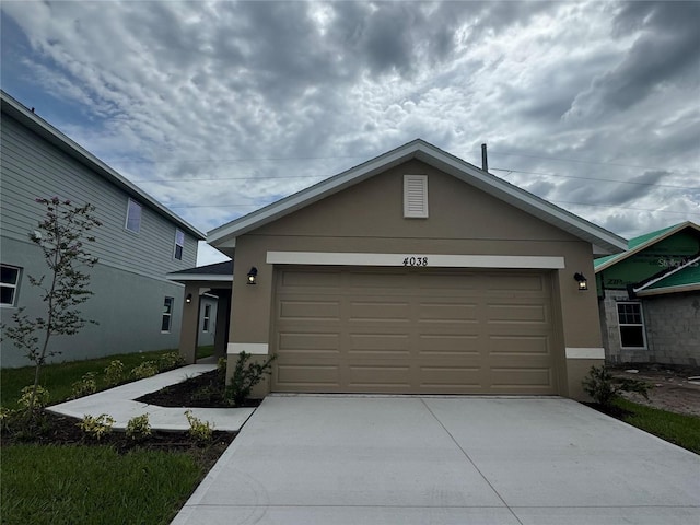 4038 Sagefield Dr, Harmony, FL 34773 - single story home featuring stucco siding, concrete driveway, and an attached garage