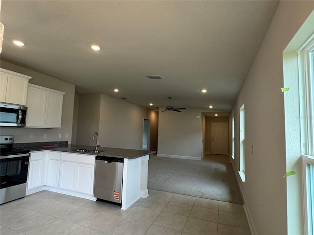 4038 Sagefield Dr, Harmony, FL 34773 - kitchen with stainless steel appliances, light carpet, a peninsula, ceiling fan, and recessed lighting