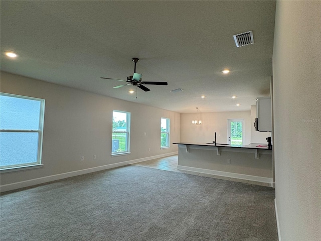 4038 Sagefield Dr, Harmony, FL 34773 - unfurnished living room with carpet, a chandelier, a ceiling fan, and recessed lighting